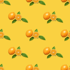 Seamless pattern with Meyer lemon and green leaves on yellow background. Fruit pattern. Tropical abstract background. Minimal fruit concept
