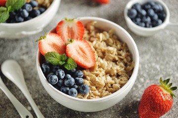 Oatmeal porridge with organic blueberries, strawberries, honey and mint.