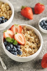 Oatmeal porridge with organic blueberries, strawberries, honey and mint.