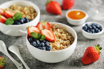 Oatmeal porridge with organic blueberries, strawberries, honey and mint.