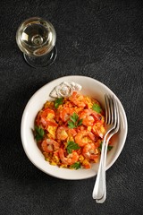 Paella or risotto with shrimp tails, carrots, onions, bell peppers, white wine and chicken stock. 