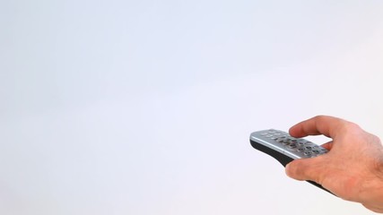 Hand Holding Remote Control And Changing Channels in White Background