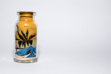 brazilian handicraft with colorful sand grains in small glass jar