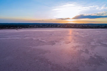 Aerial view of sunrise over pink salt lake Crosbie in Victoria, Australia