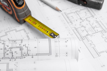 House construction plan. Hammer and measuring cup.