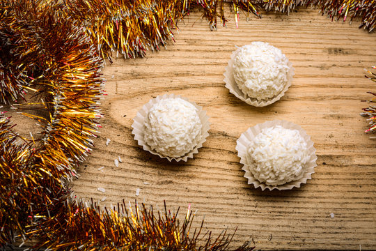 cake in coconut shavings on a wooden background