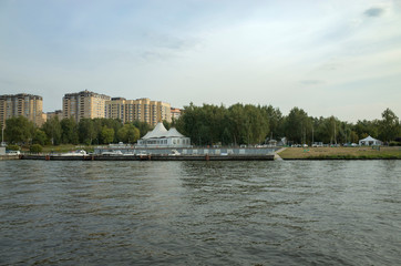 Fototapeta premium Moscow, Russia - September 8, 2018: Khimka River, Moscow Canal. Embankment Dolgoprudny. Residential buildings near the river