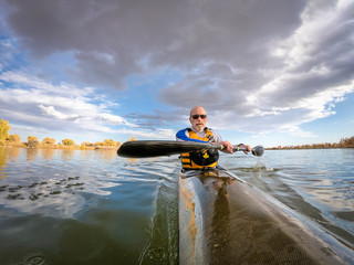 senior male paddling racing kayak