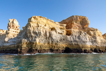 Fototapeta na wymiar Beautiful landscape of Algarve, Portugal coast with sandstone cliffs, beach and ocean under cloudless blue sky