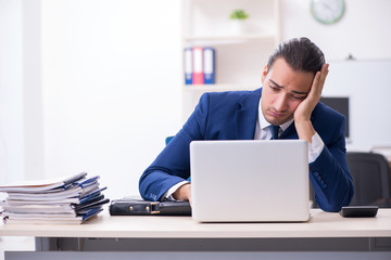 Young male businessman working in the office