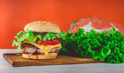 hamburger or sandwich. Delicious sandwich hamburger with meat, cheese and fresh vegetable. Hamburger or sandwich is the popular fast food for brunch or lunch. Juicy cheeseburger