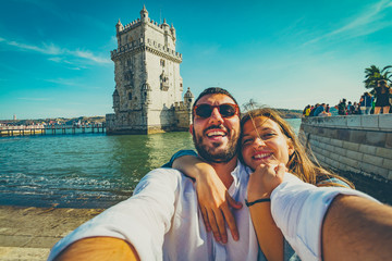 happy tourist traveling in Lisbon, taking selfie photo in the most important site of Lisbon, capital of Portugal