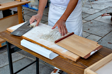 Fototapeta na wymiar Soba making, cutting the dough to noodle