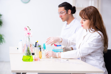 Two chemists working in the lab