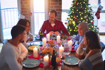 Beautiful family smiling happy and confident. Eating roasted turkey celebrating Christmas at home