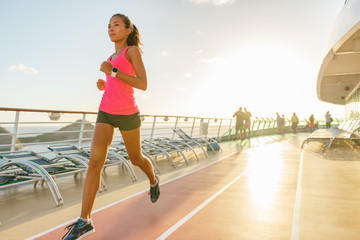 Cruise fitness running young woman jogging on deck tracks of Caribbean travel ship. Summer vacation...