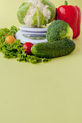 Fresh vegetables on vase on yellow background. Healthy eating, diet planning, weight loss, detox, organic farming concept