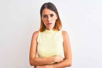 Obraz premium Beautiful redhead woman wearing yellow summer t-shirt over isolated background skeptic and nervous, disapproving expression on face with crossed arms. Negative person.