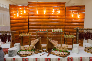Table full of tasty snacks. Ukraine traditional food - bread with lard. Sandwiches with lard and pickled cucumbers on table. Guilty pleasure - delicious, but really unhealthy food.