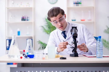 Young male chemist experimenting in lab