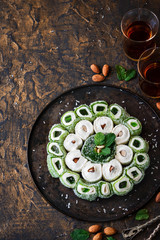 Turkish Delight. Assorted oriental sweets with nuts on a dark background.