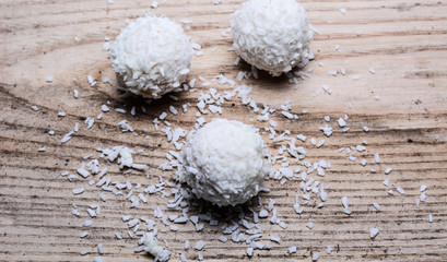 cake in coconut shavings on a wooden background