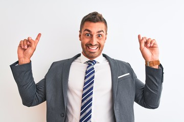 Young handsome business man wearing suit and tie over isolated background covering eyes with hands smiling cheerful and funny. Blind concept.