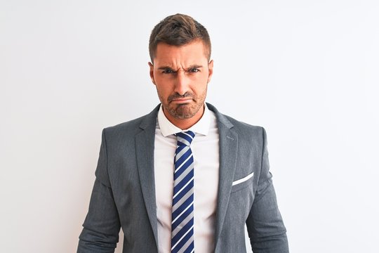 Young handsome business man wearing suit and tie over isolated background depressed and worry for distress, crying angry and afraid. Sad expression.