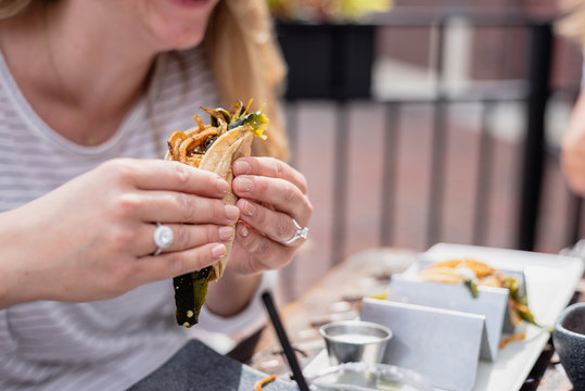 Woman Holding A Taco