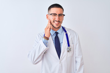 Young doctor man wearing stethoscope over isolated background touching mouth with hand with painful expression because of toothache or dental illness on teeth. Dentist concept.