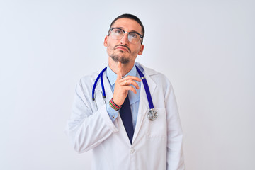 Young doctor man wearing stethoscope over isolated background Thinking concentrated about doubt with finger on chin and looking up wondering