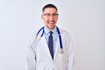 Young doctor man wearing stethoscope over isolated background winking looking at the camera with sexy expression, cheerful and happy face.