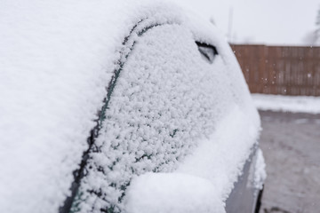 Snow lies on a car. Snow. White snow flakes. Cold weather.