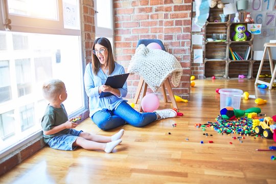 Young therapist woman speaking with child, counselor and behaviour correction at the office around toys