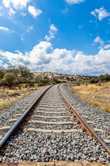Fototapeta premium Railway train tracks in the sunny landscape