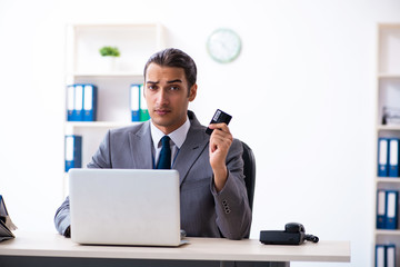 Young male accountant working in the office