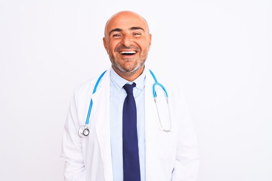 Middle age doctor man wearing stethoscope and tie standing over isolated white background with a happy and cool smile on face. Lucky person.