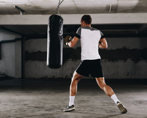 Fearles MMA Fighter practicing his punch on a punching bag