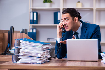 Fototapeta premium Young handsome businessman working in the office