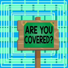 Text sign showing Are You Covered Question. Business photo text asking showing if they had insurance in work or life Wood plank wooden stick pole paper note attached adhesive tape empty space