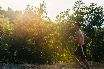 Muscular fit sport silhouette model sprinter exercising sprint on forest road