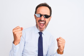 Middle age businessman wearing thug life sunglasses over isolated white background very happy and excited doing winner gesture with arms raised, smiling and screaming for success. Celebration concept.