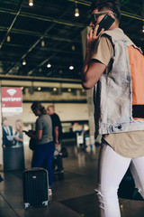 Man with backpack talking on smartphone in the airport