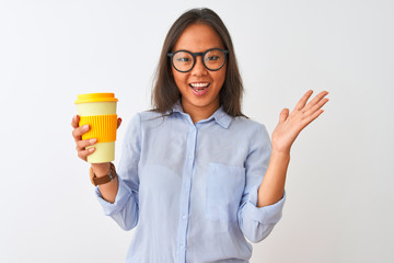 Young chinese woman wearing glasses holding glass of coffee over isolated white background very happy and excited, winner expression celebrating victory screaming with big smile and raised hands