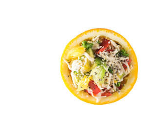 Half orange filled with chicken and avocado salad isolated on white background.
