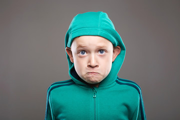 Funny child. expression little boy in hood