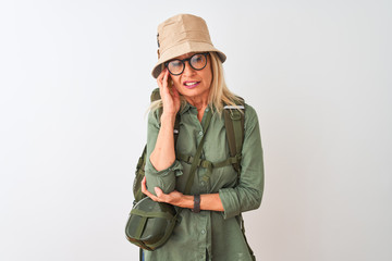Middle age hiker woman wearing backpack hat canteen glasses over isolated white background thinking looking tired and bored with depression problems with crossed arms.