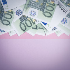 Euro cash on a lilac, purple and pink background. Euro Money Banknotes. Euro Money. Euro bill. Place for text.