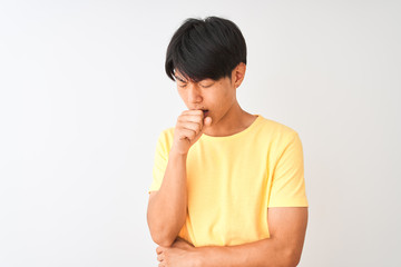 Chinese man wearing yellow casual t-shirt standing over isolated white background feeling unwell and coughing as symptom for cold or bronchitis. Healthcare concept.