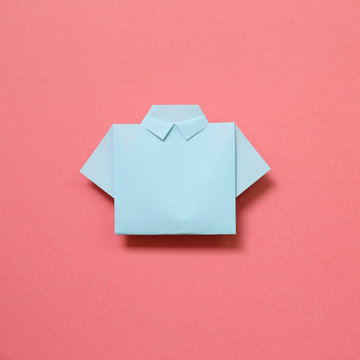 Blue paper shirt origami on pink background